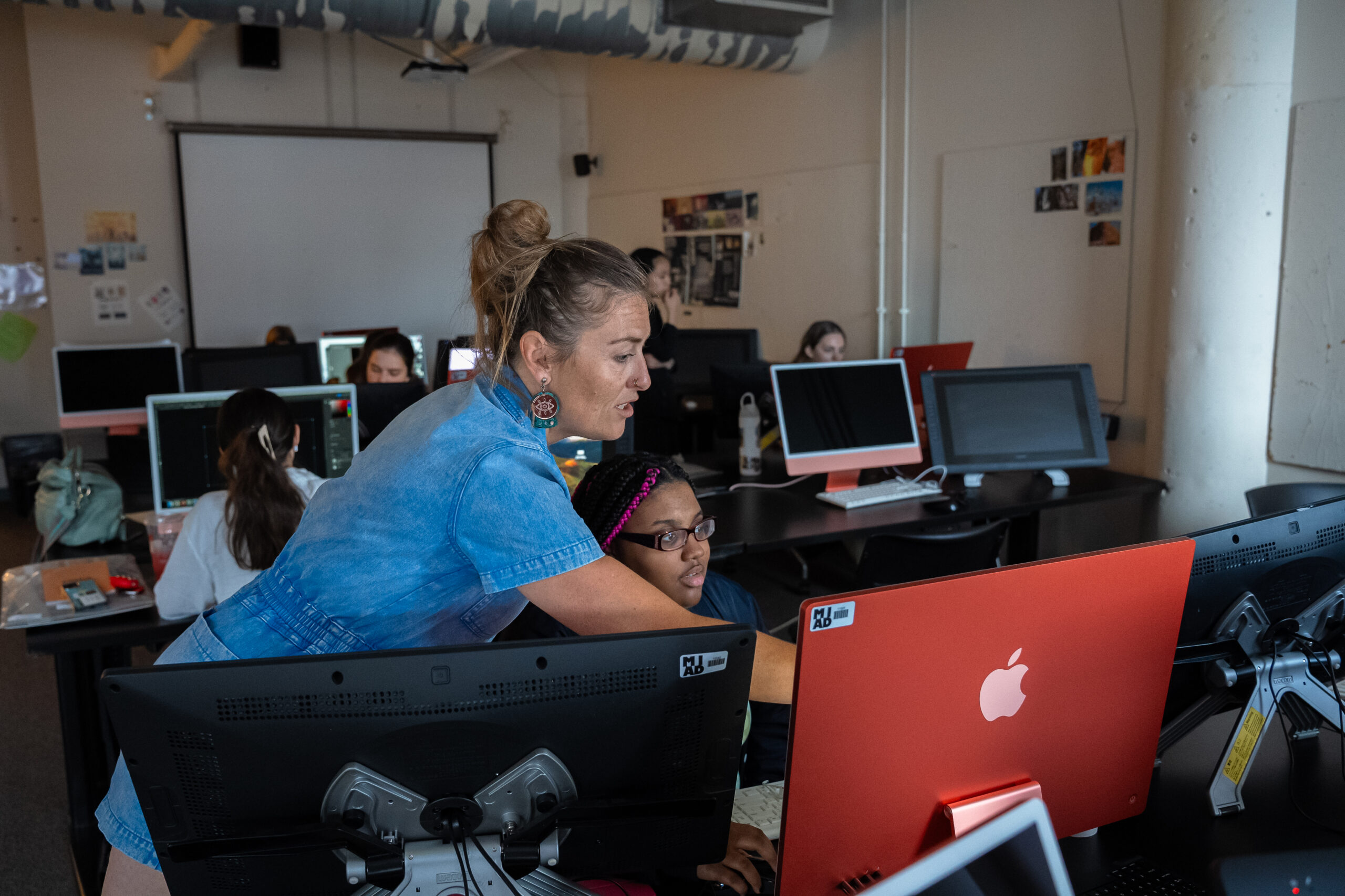 A group of three students works on a project in the MIAD textiles lab.